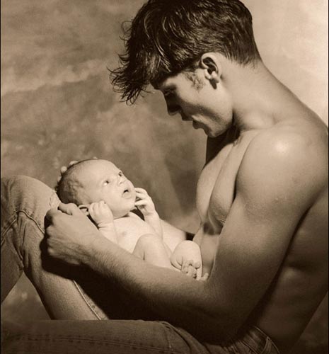 90s man holding baby 90210 style man holding baby photo